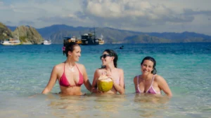 Tourists having fun at the beach Labuan Bajo during sunset trip